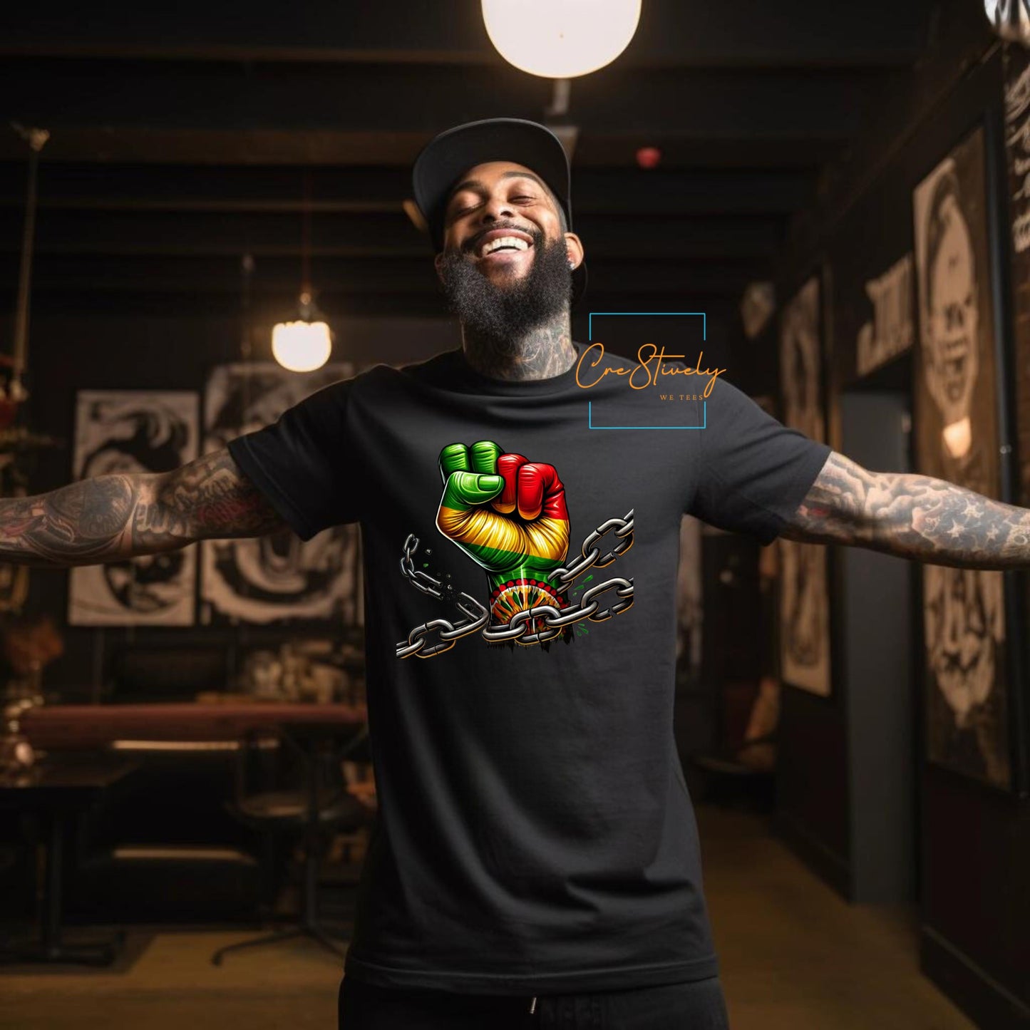 Smiling man spreading his arms in a black t-shirt featuring a raised RBG fist breaking chains, expressing freedom, resistance, and strength in Black culture.