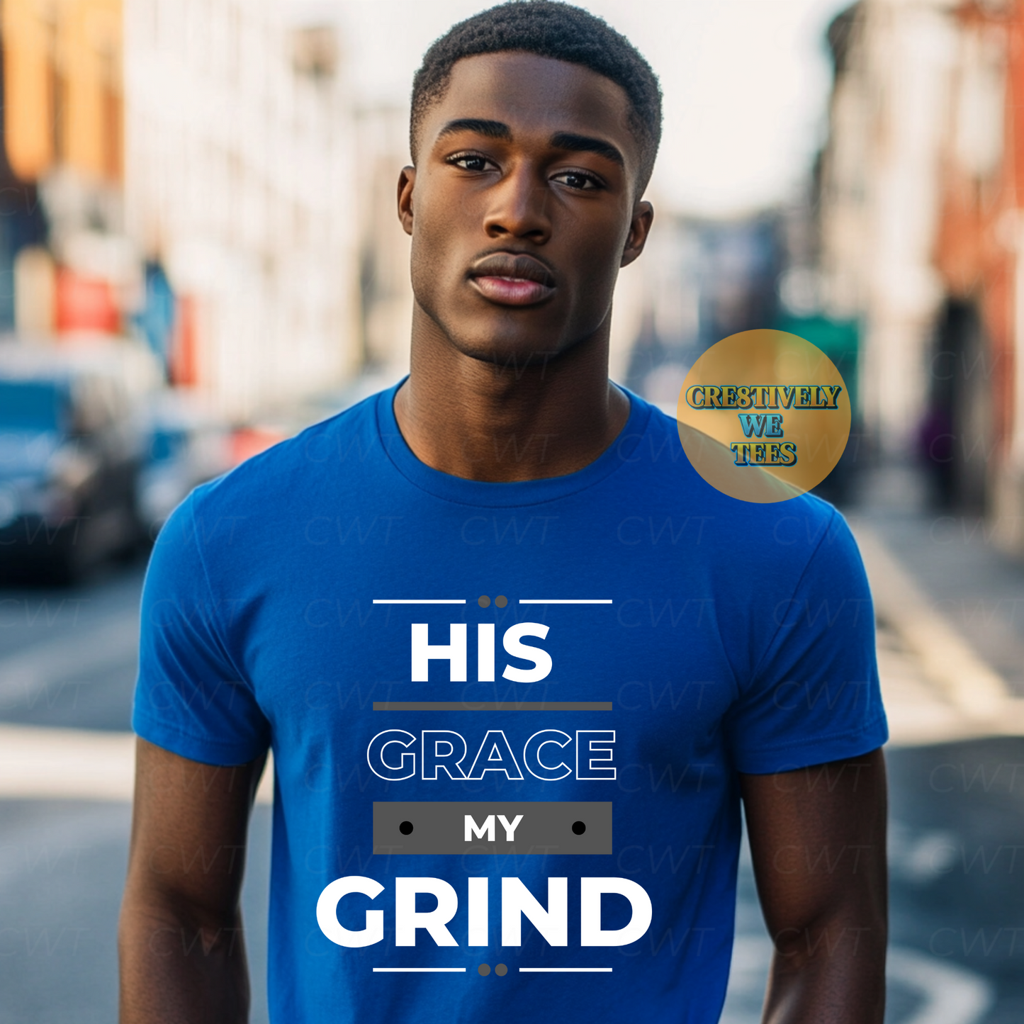 Young man wearing a blue T-shirt with the phrase “His Grace My Grind,” symbolizing faith and hustle, posing outdoors