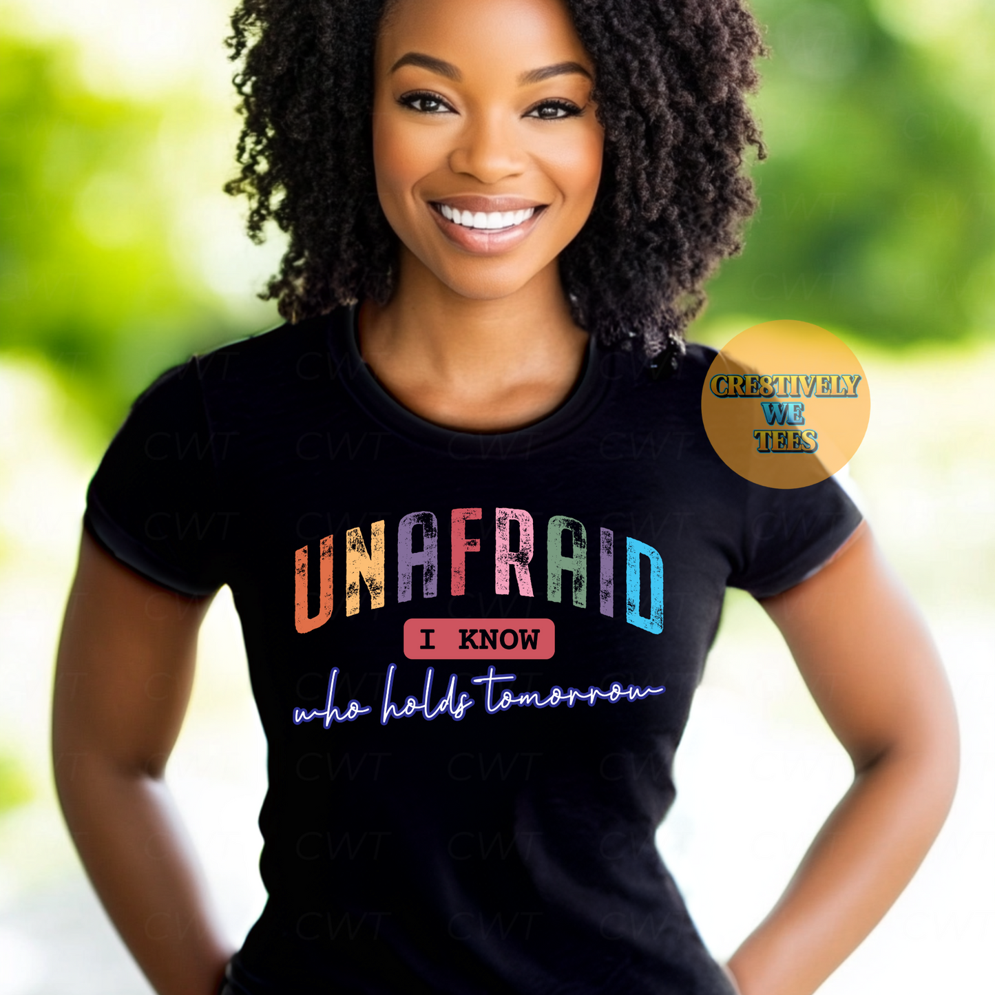 Beautiful woman wearing a black t-shirt with a colorful graphic that states "Unafraid I know who holds tomorrow"