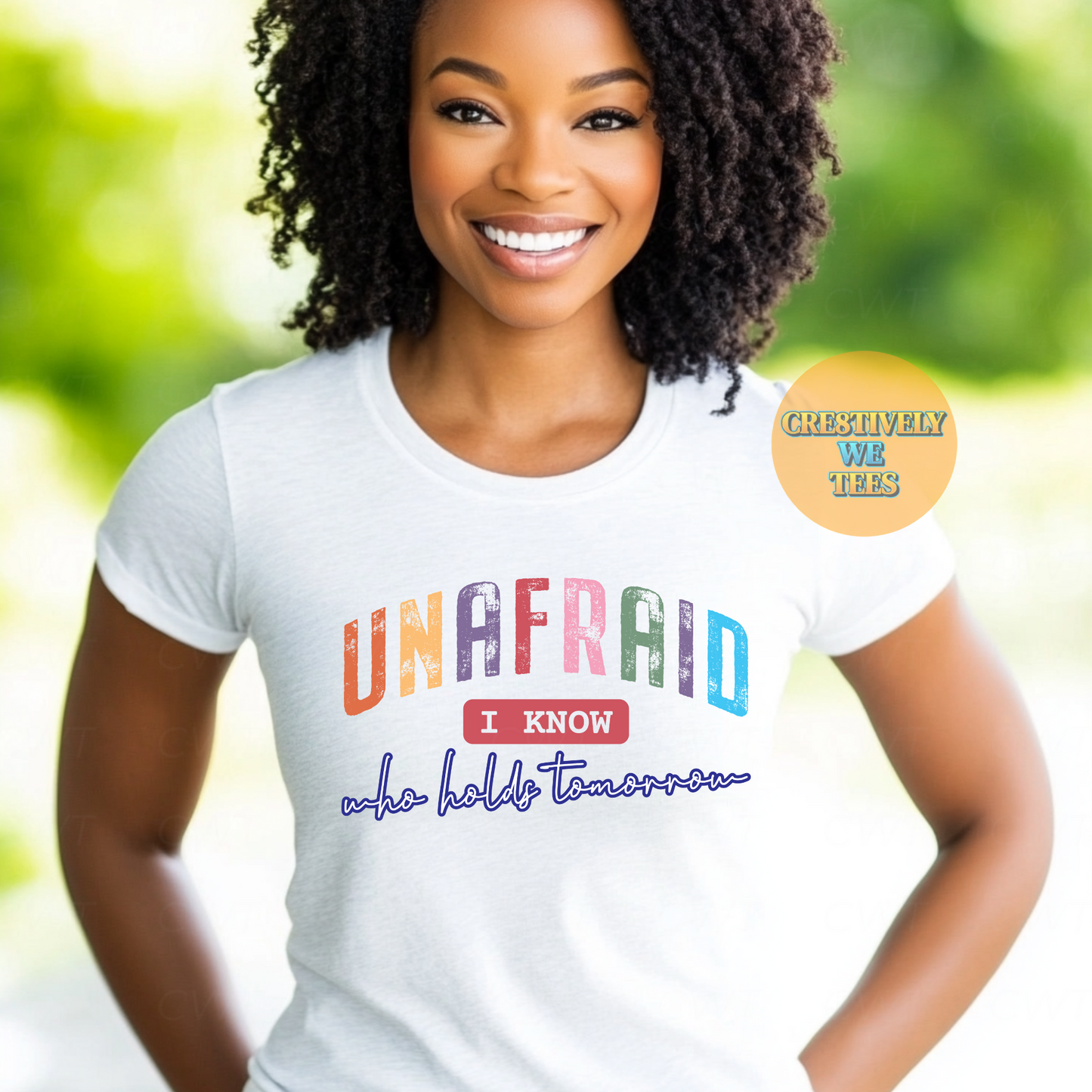 Beautiful woman wearing a white t-shirt with a colorful graphic that states "Unafraid I know who holds tomorrow"