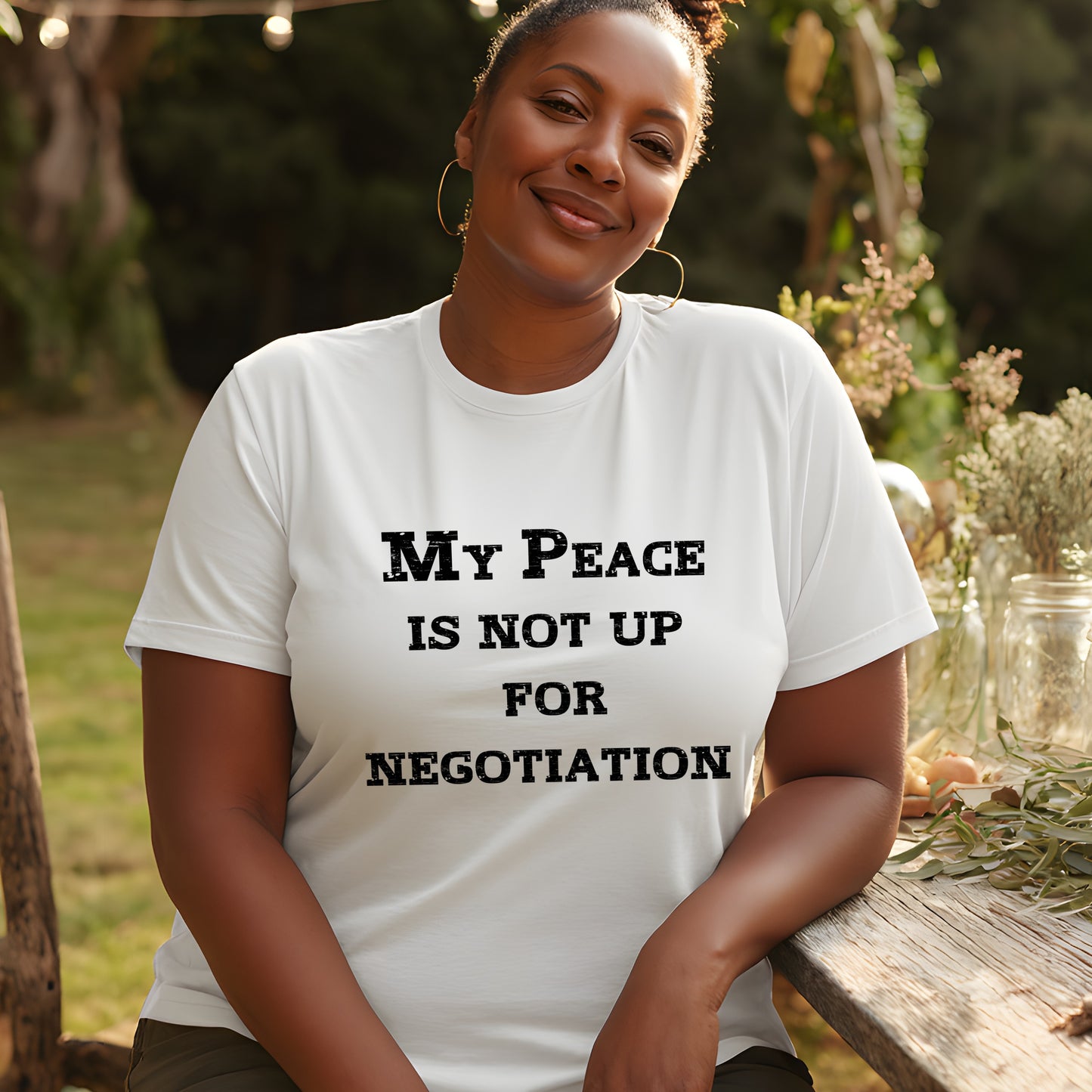 Confident woman sitting outdoors wearing “My Peace Is Not Up For Negotiation” tee; bold statement shirt for self-care and empowerment.