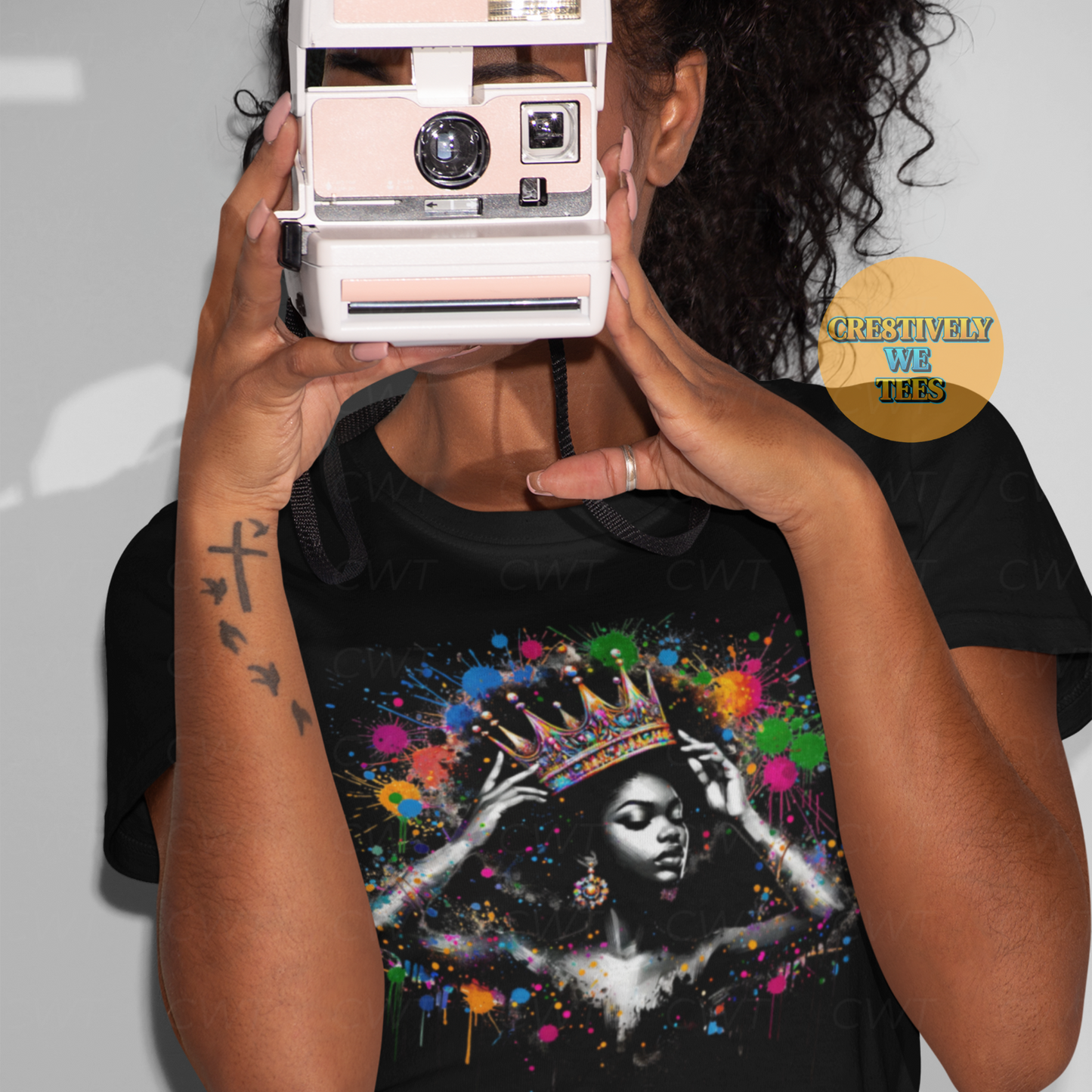 Black woman wearing Queen Things t-shirt with colorful afrocentric crown artwork, holding vintage camera – Cre8tively We Tees.