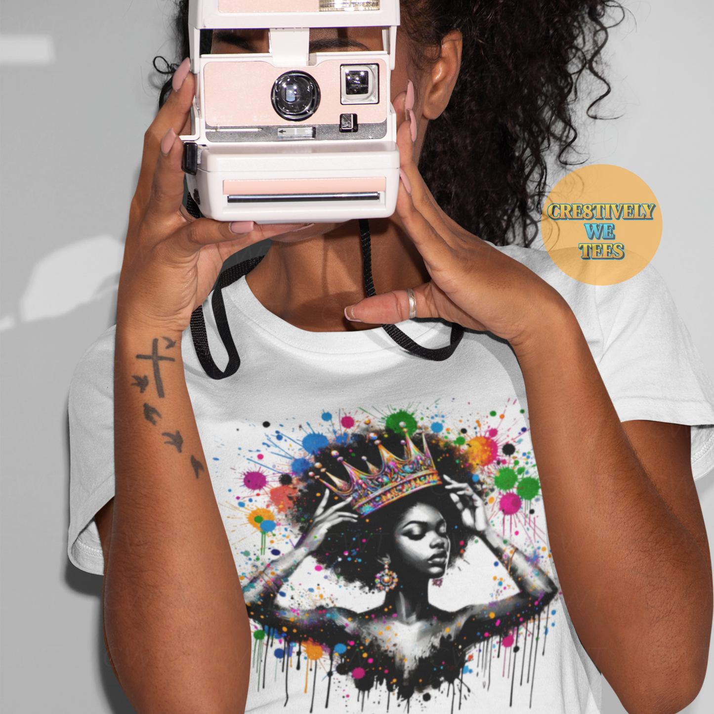White Queen Things graphic tee showing Black woman in crown with multicolor paint splatter design – vibrant afrocentric fashion.