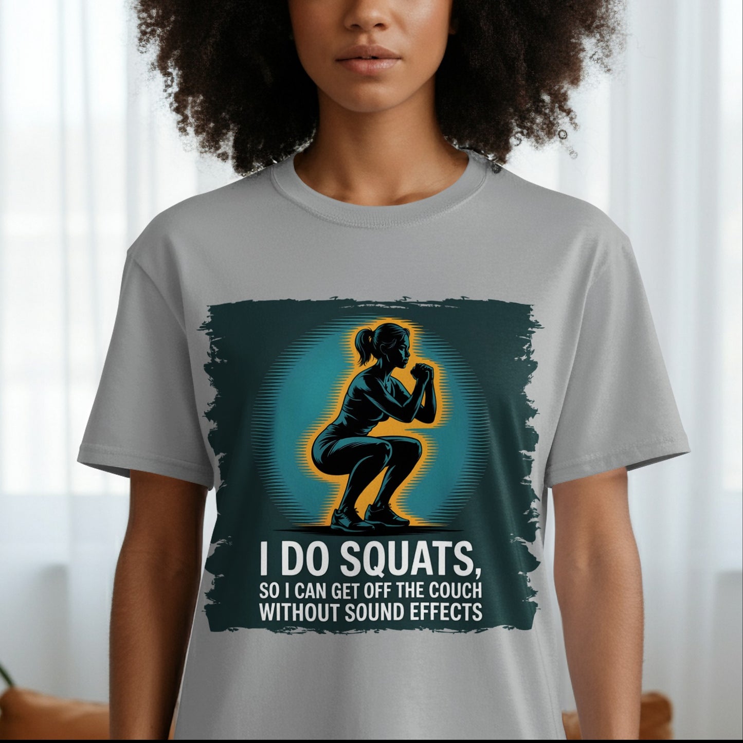 Woman wearing gray t-shirt with squat silhouette and funny fitness quote for gym lovers