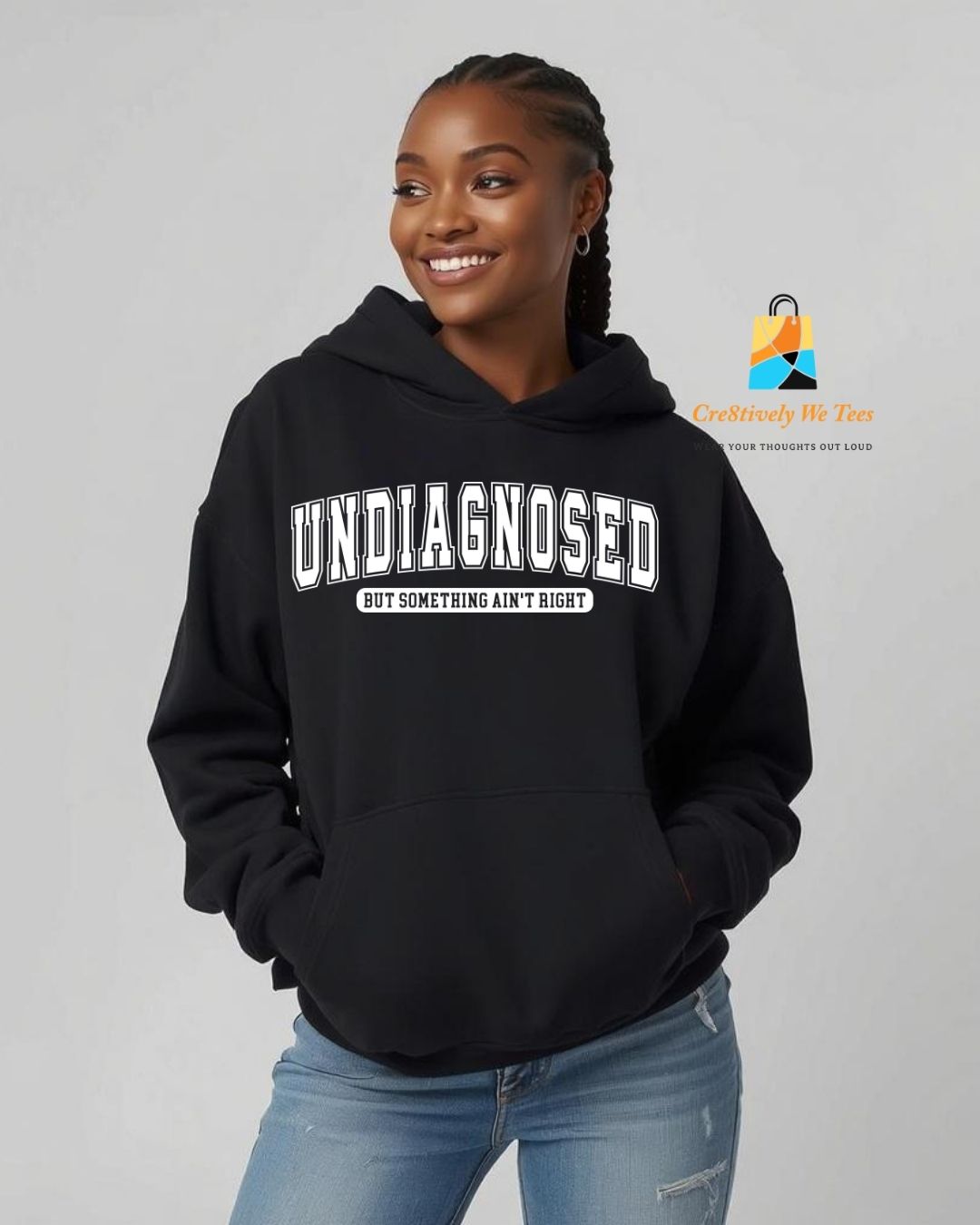 Person wearing a black hoodie with 'undiagnosed' text, standing against a plain background.
