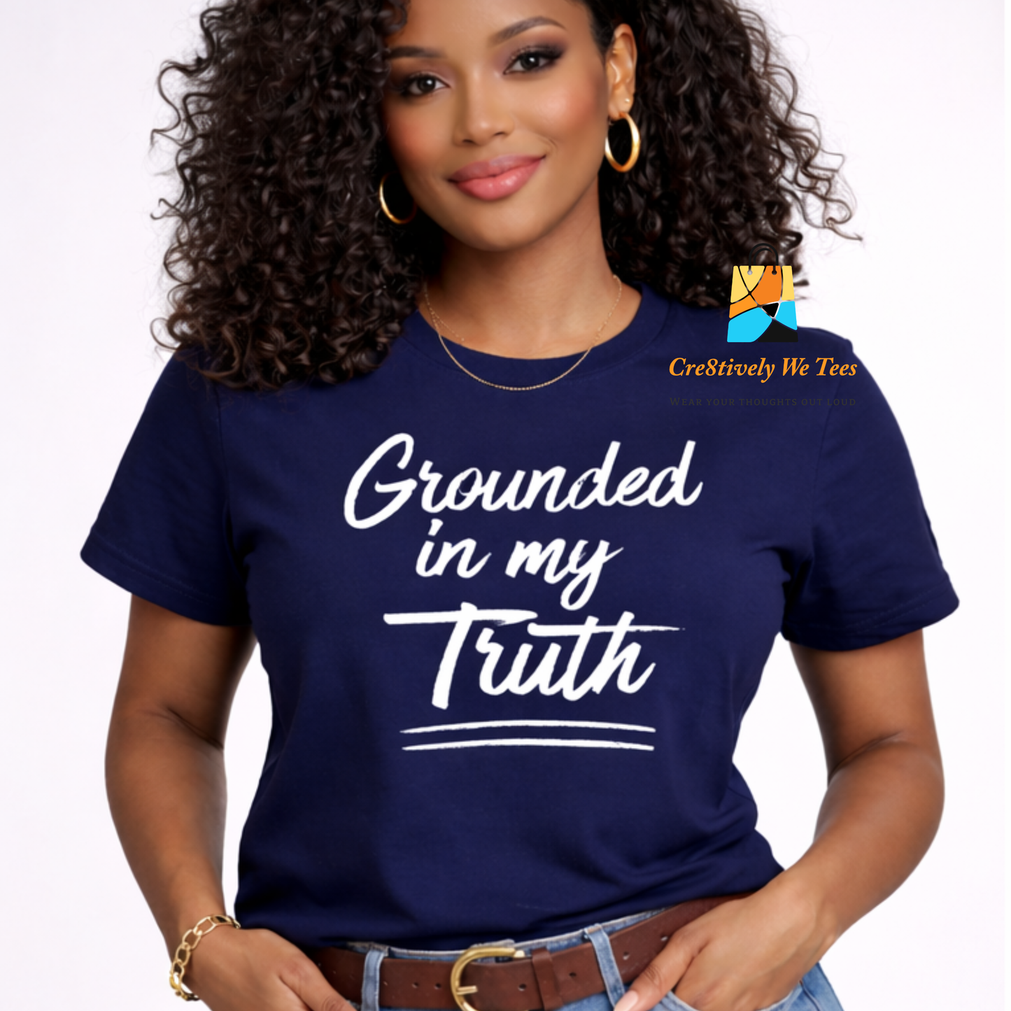 Woman wearing a navy blue t-shirt with 'Grounded in my Truth' text, standing against a plain background.