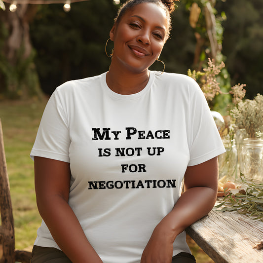 Confident woman sitting outdoors wearing “My Peace Is Not Up For Negotiation” tee; bold statement shirt for self-care and empowerment.